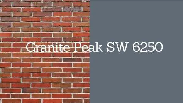 Granite peak paint swatch held against red brick